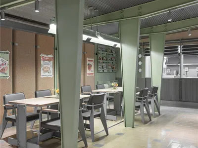A well-lit restaurant space with multiple dining tables and chairs, suitable for socializing and meals
