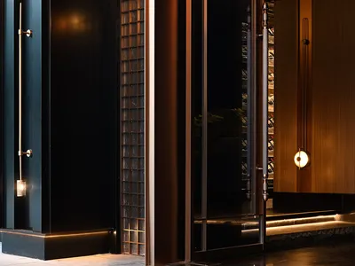 A hotel lobby with a brown color scheme, featuring a large glass door, two side doors, and potted plants along the hallway
