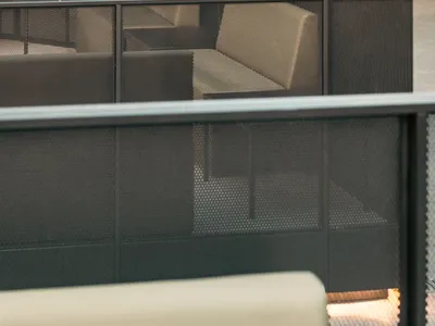 Comfortable indoor space with multiple couches and chairs arranged around a central point, creating a warm and inviting atmosphere for socializing and relaxation