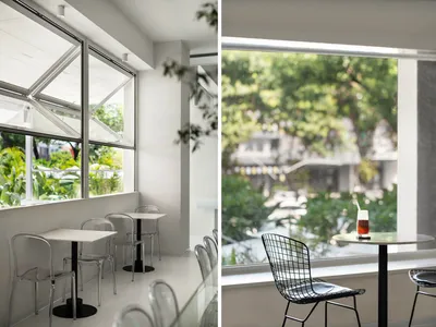 A restaurant with multiple dining tables and chairs, both inside and out, creating a welcoming atmosphere for guests