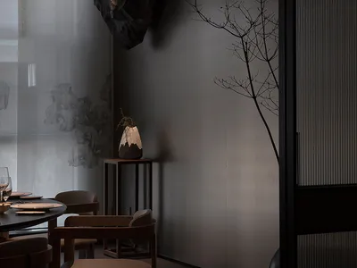 Sophisticated dining area with a large table, gray walls, and a rock sculpture centerpiece
