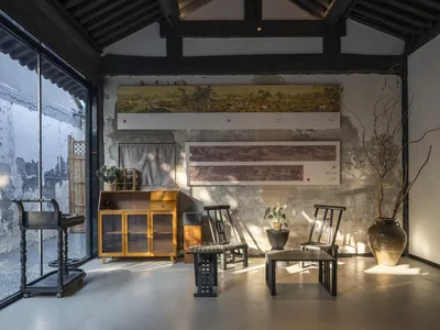 A well-lit interior design showroom with various pieces of furniture, plants, and inviting ambiance