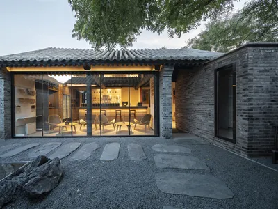 A modern Asian restaurant with a large dining area featuring multiple tables and chairs, creating an inviting and comfortable atmosphere