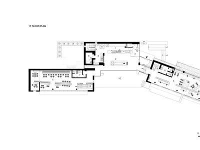 2D floor plan of a modern hotel or office complex with various rooms and spaces, clean lines, and minimalistic elements