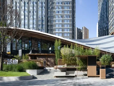 A large open space with multiple seating options, benches, and chairs, designed for relaxation and socializing in a hotel lobby setting