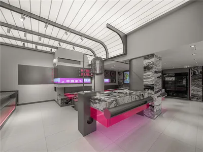 Modern hotel lobby with a pink and grey marble counter, chairs, and clean lines