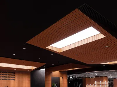 A well-lit restaurant interior with wooden floors and tables, featuring comfortable seating and a welcoming atmosphere