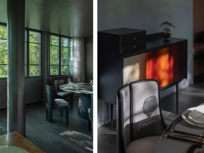 Dining area with chairs, tables, and wine glasses in a sophisticated black and grey interior design