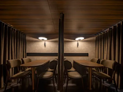 Cozy dining area with brown tables and chairs, well-lit and inviting atmosphere