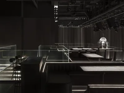 Dark and intimate dining space with modern design, clean lines, and minimalistic decorations