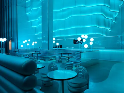 Bright and inviting restaurant interior with modern design, natural light, and multiple tables and chairs