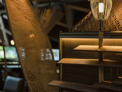 Cozy dining space with a wooden table, woven chairs, and warm lighting