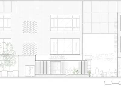 Modern restaurant exterior with a white facade, large windows, and natural light, set amidst a bustling street scene