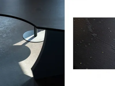 Close-up of a marble kitchen countertop with a modern and sophisticated design, set against a larger view of the same countertop