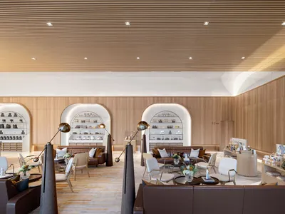 Elegant showroom with seating areas, dining tables, and wine glasses, set in a stylish and inviting environment