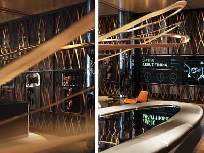 Modern interior space with chairs and a clock on the wall, featuring a stylish and functional design