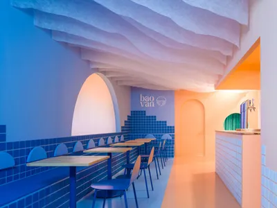 A restaurant dining area with multiple tables and chairs, creating a welcoming atmosphere for meals and socializing