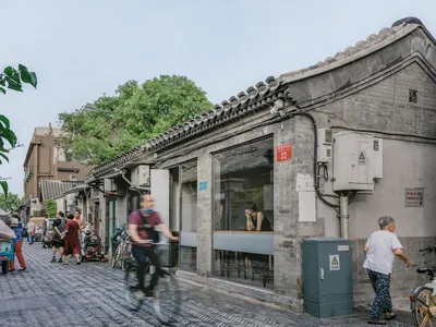 A restaurant with a blend of stone and wood elements, featuring a mix of traditional and modern styles, with a cozy ambiance and warm atmosphere