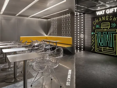 A cozy restaurant dining area with chairs, tables, benches, and bottles on the walls, perfect for socializing and enjoying meals together