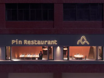 A well-lit restaurant dining area with tables and chairs, creating a cozy atmosphere for people to enjoy meals together