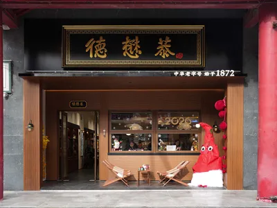 Cozy Asian restaurant with wooden floors, walls, and furniture, creating a warm atmosphere