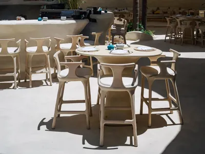 A spacious restaurant interior with multiple dining tables and chairs, creating an inviting atmosphere for a relaxed dining experience
