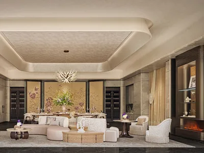 Spacious living area with a couch, chairs, coffee table, and dining table, featuring luxurious and inviting decor