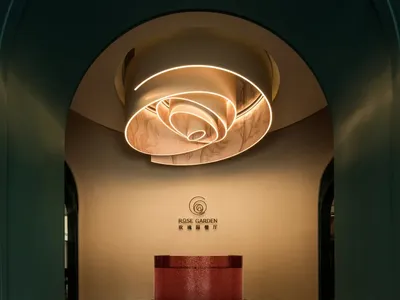 A modern hotel lobby with a red countertop, likely made of marble or granite, in an elegant and inviting atmosphere