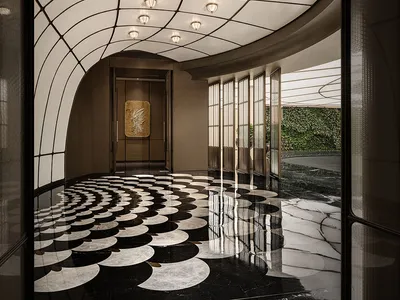 A grand hallway with an arched ceiling, checkered floor, and overhead lighting, creating an elegant and sophisticated atmosphere