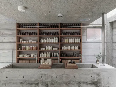 Bathroom with a sink and multiple shelves displaying various bottles of soap, creating a clean and organized atmosphere