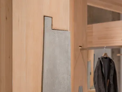 A well-organized retail space with clothing items on walls and in display areas, creating a stylish atmosphere with jackets and coats on display