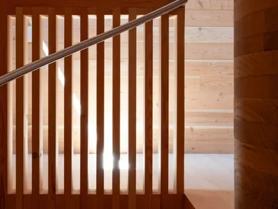 A wooden staircase with a painting of a person above the steps, adding an artistic element to the space
