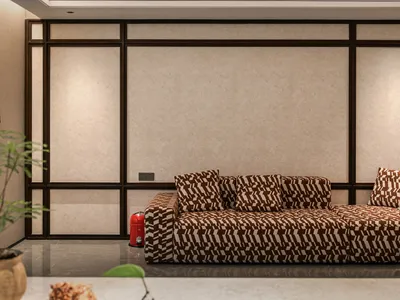 Cozy living room with a brown couch, zebra print pillows, and a potted plant on a hardwood floor, with a fire hydrant in the corner