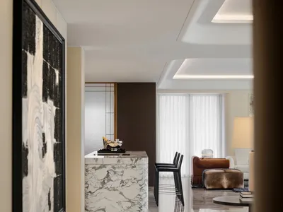 Sophisticated living room with marble countertop, black chair, two couches, dining table, and vase, set in a well-decorated modern space