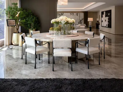 Sophisticated dining space with a large table, potted plants, and a modern chandelier