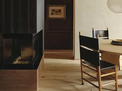 Cozy living area with a dining table, chairs, and a fireplace, creating a warm and inviting atmosphere