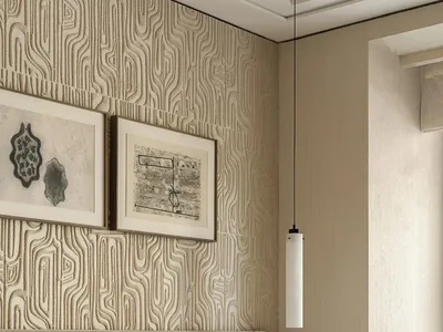 A well-lit bedroom with a striped pattern on the walls, a large bed, and two pictures above it