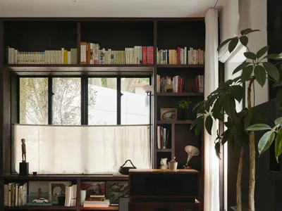 Cozy living space with a large bookshelf, a couch, and a diverse book collection