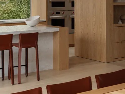 Modern kitchen with wooden cabinets, granite countertops, stainless steel appliances, and natural light from a large window