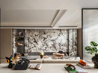 Cozy living space with a couch, dining table, bookshelf, and decorative elements, well-lit by natural sunlight