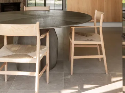 Warm and inviting kitchen and dining space with wooden floors and cabinets, featuring a dining table and chairs, and decorative bowls
