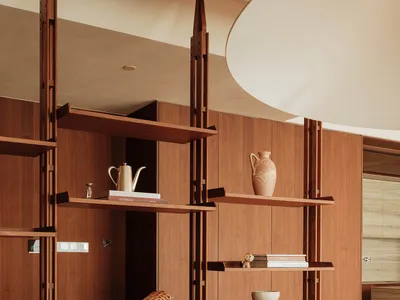 Warm and inviting living area with wooden cabinets, two chairs, and a bowl, creating a cozy and comfortable environment
