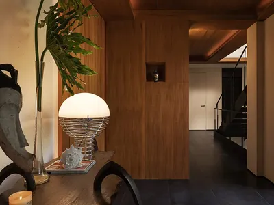 A warm and inviting dining area with a wooden table and chairs, a potted plant, and a cozy atmosphere