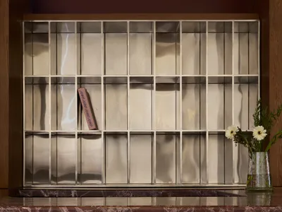 A marble countertop with a pink paperback book placed on it, set in a room with a wooden countertop and an elegant atmosphere