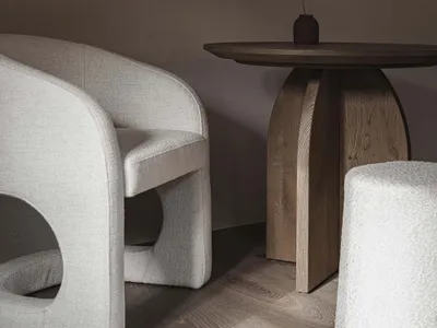 A cozy living space with a wooden table and two chairs, surrounded by a warm and inviting atmosphere