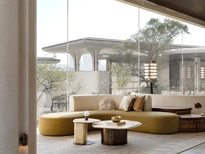 A well-lit living room with a large couch, coffee table, and various decorative items, creating a cozy and inviting atmosphere