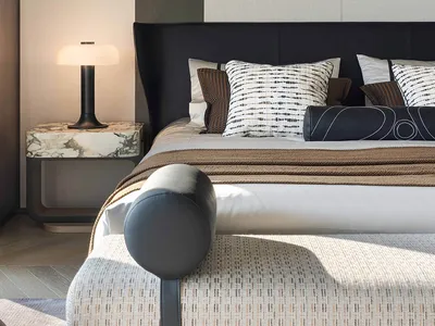 Cozy bedroom with a striped wall, a bed, a chair, and a skateboard painting on the wall