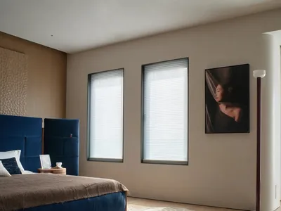 A well-lit bedroom with a bed, chair, and painting, featuring predominantly wooden materials and a comfortable atmosphere