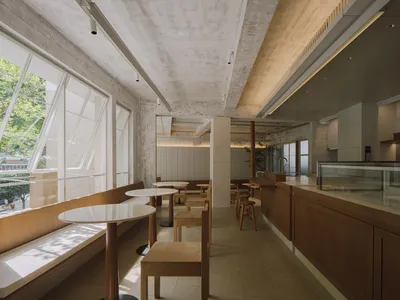 Bright and inviting restaurant interior with wooden furniture, white walls, and natural lighting