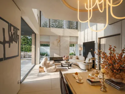 Bright and welcoming living room with modern furniture, natural light, and decorative items